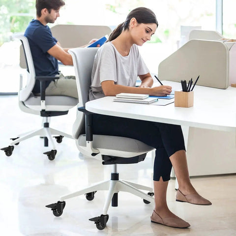 Modern office setting with two people using office chairs equipped with 2 Inch Office Chair Caster Wheels With Brakes Heavy Duty Set Of 5 Replacement Universal Rolling Chair Wheels For Hardwood Floors And Carpet Rubber Desk And Gaming Chair Casters With Locks 11mm Stem Fits 98 Percent Of Chairs.