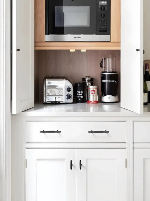 White cabinet with Five Pack Oil Rubbed Bronze Knurled Cabinet Handles With 3.78 Inch Center To Center 96mm Hole Spacing.