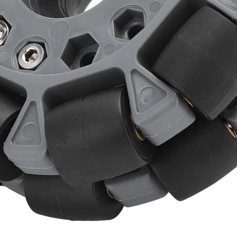 Close-up of Omni Wheel for Robot 100mm 360 Degree Omnidirectional Plastic Wheel showing rubber rollers and brass bearings.
