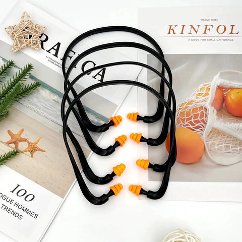 Orange Banded Earplugs For Shooting Range 4 Piece Set Reusable Silicone Hearing Protection With Neck Band displayed on magazines