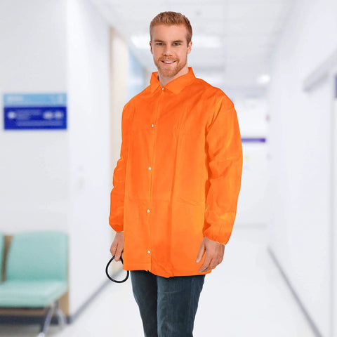 Man wearing an orange disposable lab jacket with elastic wrists, snap front, and collar in a medical setting.