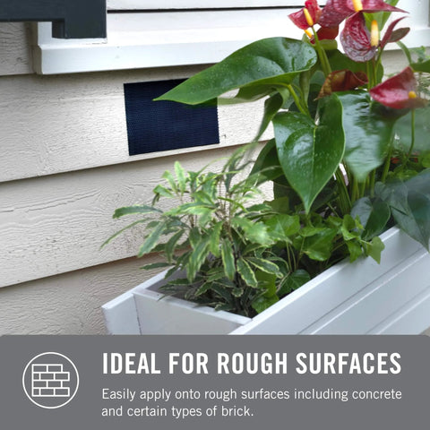 Extreme Outdoor Double Sided Mounting Tape Built To Handle Up To 15 Pounds On Brick Or Rough Surfaces UV And Weather Resistant 14 Ft Roll installed on a wall with a planter box.