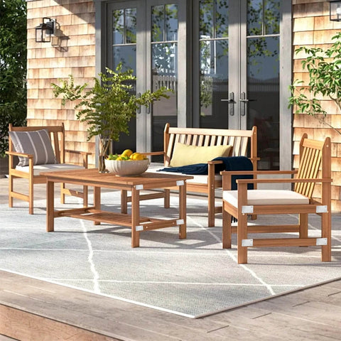 Wooden outdoor patio furniture set with chairs, bench, and table on a deck with shingles and glass doors in the background.