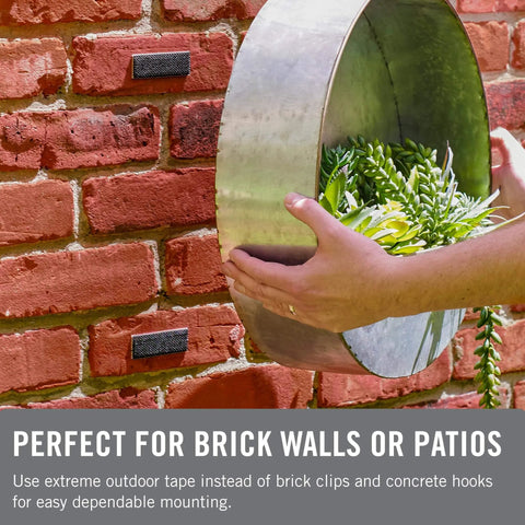 Extreme Outdoor Double Sided Mounting Tape Built To Handle Up To 15 Pounds On Brick Or Rough Surfaces UV And Weather Resistant 14 Ft Roll applied on brick wall supporting metal planter