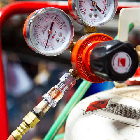 Close-up of an Oxy-Fuel Quick Connect Regulator To Hose Coupler Set For Fuel And Oxygen connected to a gas cylinder.