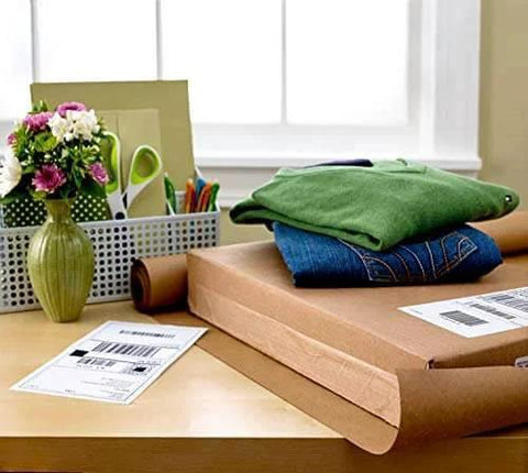 Packing materials and folded clothes on desk, showcasing Scotch Sure Start Packing Tape Clear 1.88 In X 22.2 Yd 6 Dispenser Rolls Quiet Unwind Easy Start Strong Hold
