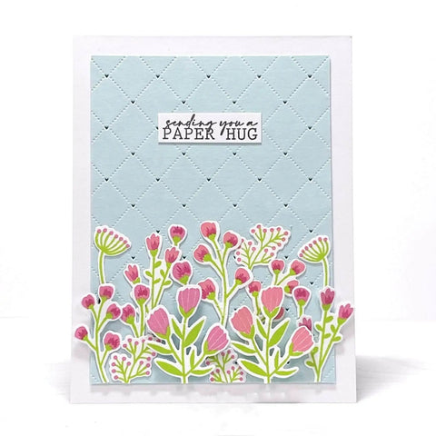 Greeting card with pink flowers and a quilted blue background, featuring a 'sending you a paper hug' message.