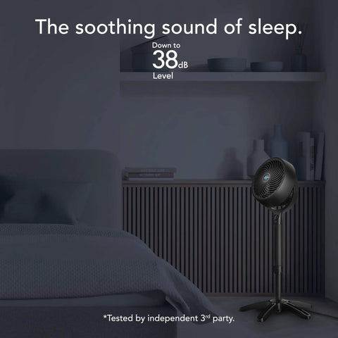 All Day Chill Pedestal Fan With Three Speed Control And Height Adjustable From 32 To 38 Inches Delivers Whole Room Air Circulation And Quiet Operation For Bedroom And Home By Vornado placed in a bedroom setting.