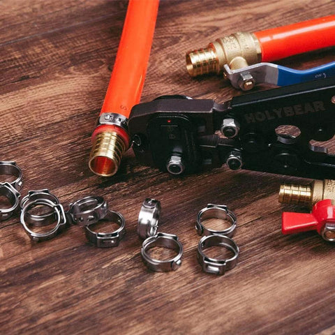 Three Quarters Inch PEX Cinch Clamp Rings in Premium 304 Stainless Steel Thickened Design for 360 Degree Watertight Seals displayed on wooden surface
