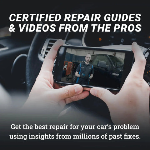 Person viewing car repair video on smartphone inside vehicle.