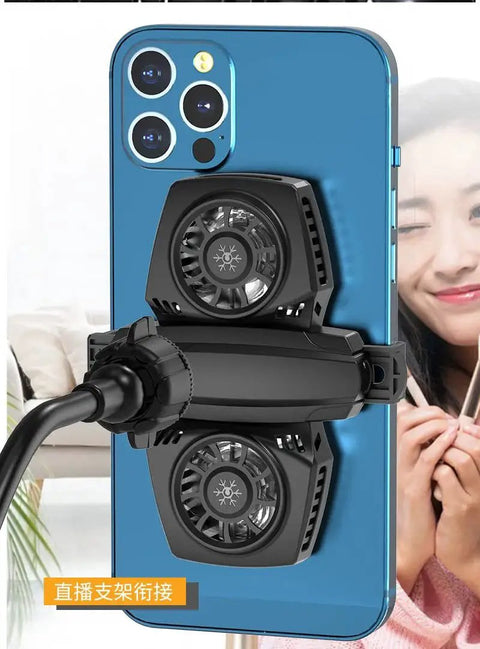 Smartphone with cooling fans attached to the back, smiling person in the background, visible mount adapter.