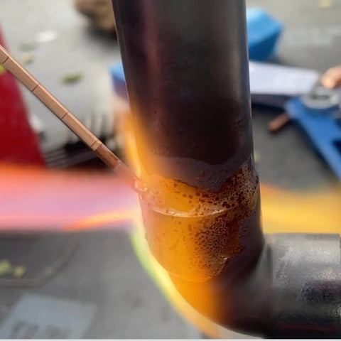 Close-up of welding using phosphor copper rod from Refrigerator Filter Dryer With Access And Service Valve And Three In One HVAC Tool Kit.
