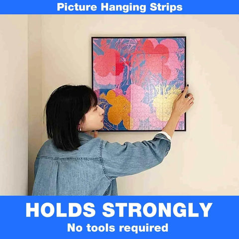 Person hanging picture using Heavy Duty 1 Inch By 20 Foot Self Adhesive Hook And Loop Tape Interlocking Strip For Mounting And Hanging