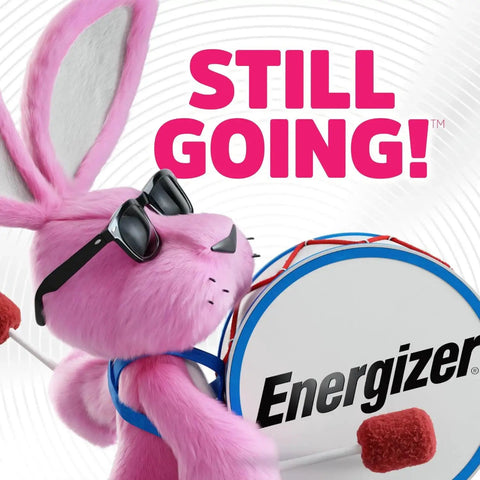 Pink bunny with drum and sunglasses, promoting reliability and long-lasting power of Energizer batteries with slogan "Still Going!".
