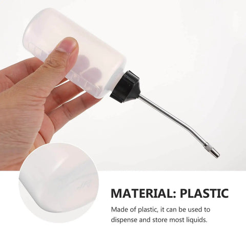Person holding a plastic oil can with metal spout from the Three Piece Sewing Machine Oil Can Set With Iron Spout And Cap For Precise Lubrication On Sewing Machines Engines And Machinery Maintenance Tools And Dispenser For Handheld Use And Everyday DIY Repairs.