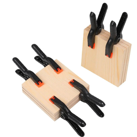 12 Pack 3.5 Inch Plastic Spring Clamps Heavy Duty Nylon Craft Clips For Backdrop Stands Woodworking And Photography Studios in use on wood.