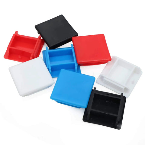 Assorted colored plastic end caps for struts, shown in red, blue, black, white. Protect and seal universal channel ends with durable plastic.