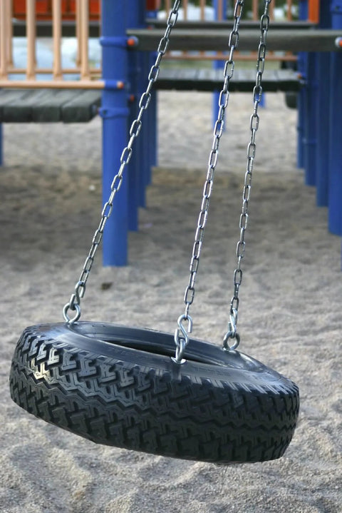 Tire swing supported by chains at playground, illustrating potential use of 699481 1/4" x 10' Zinc Plated Grade 30 Proof Coil Chain, Silver.