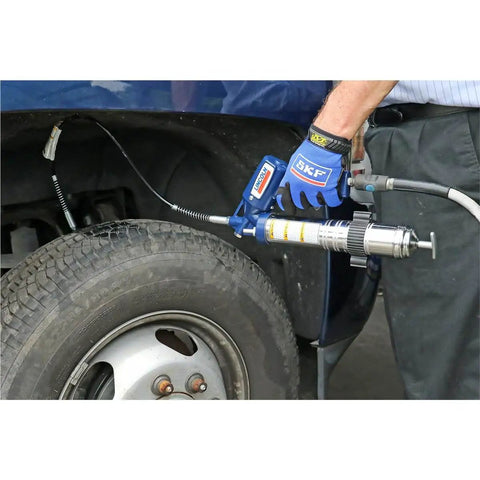 Heavy Duty Pneumatic Grease Gun With 30 Inch High Pressure Hose And 6000 PSI Power, being used on vehicle wheel for lubrication
