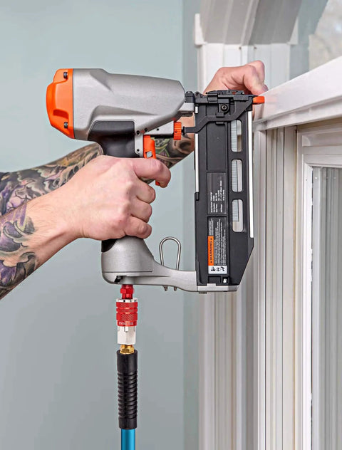 Person using Sixteen Piece Universal Air Hose Fittings And Quick Connect Kit with pneumatic tool near window frame in DIY setup