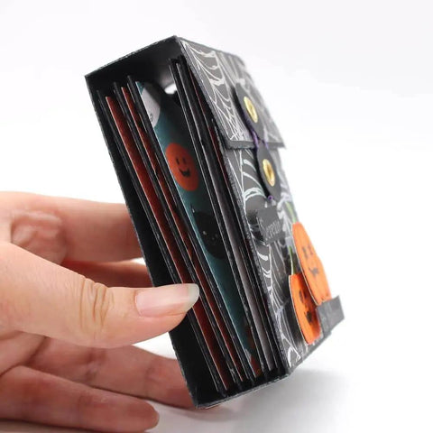Side view of ATC Cards Pocket Folder Metal Cutting Dies Stencil Set for DIY Scrapbooking, held by hand, showing layered design.