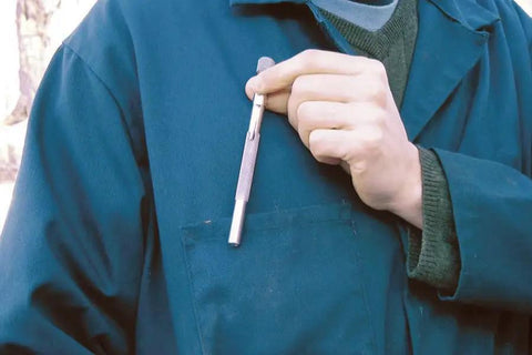 Person holding Pocket Model Grease Joint Rejuvenator Tool By IPA Tools Innovative Products Of America against a blue uniform pocket.