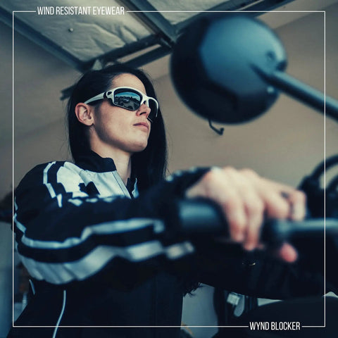 Person wearing Blocker Polarized Motorcycle Riding Sunglasses Sports Wrap Black Smoke Lens on a motorcycle.
