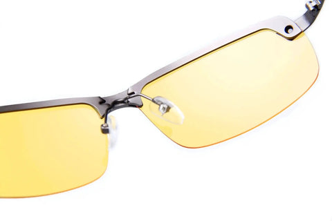 Close-up of Polarized Night Driving Glasses Anti Glare For Enhanced Night Vision with yellow-tinted lenses and metal frame.