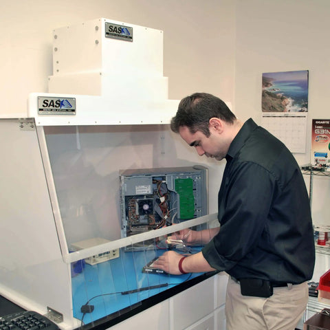 Technician working with a computer under a 30 Inch Wide Portable Laminar Flow Hood Lab Grade For Medical And Laboratory Use with Positive Pressure