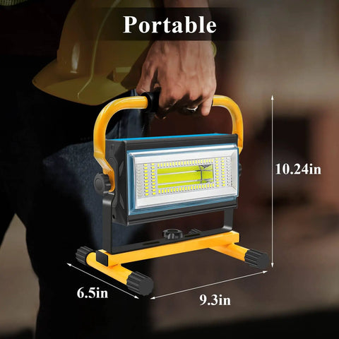 Person holding Rechargeable 100W LED Work Light With Beast Mode Brightness And 7000LM Output, Cordless Flood Light With Stand