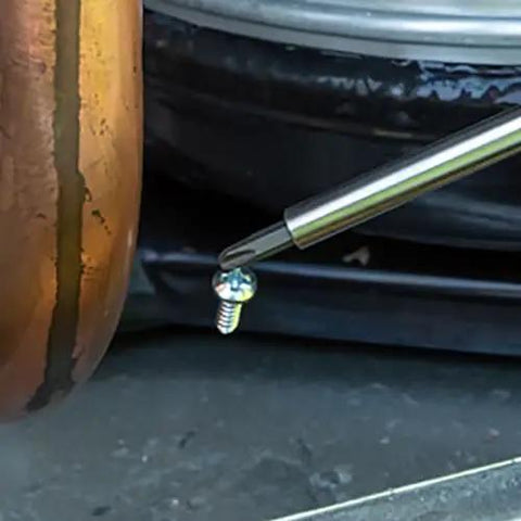 Close-up of All-In-One 27-In-1 Precision Screwdriver Set For Apple Device Repairs with tip near a small screw