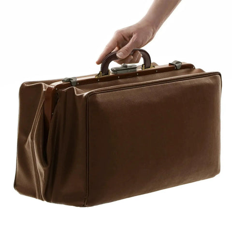Hand holding a suitcase with a PU Leather Luggage Handle Replacement Strap For Travel Bags Guitar And Musical Boxes Gift Boxes Vintage U Shape