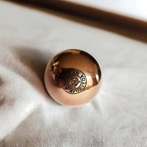 Close-up of 1.5 Inch Pure Solid Copper Ball from 2 Pack, showcasing polished surface and engraved logo for grounding therapy