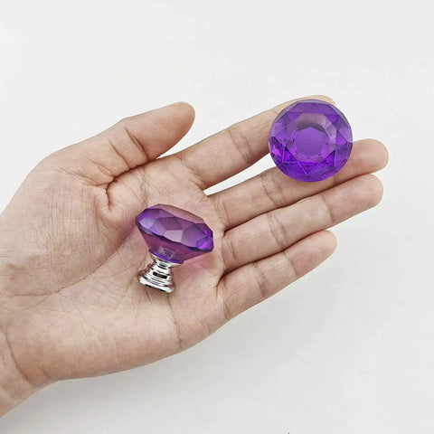 Hand holding two Purple Diamond Crystal Cabinet Knobs 1.2 Inch with Chrome Alloy Bases, showing crystal glass detail and chrome base.
