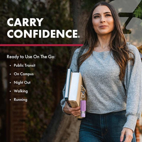 Woman holding books and compact police-strength pepper spray with quick release keychain for fast access outdoors