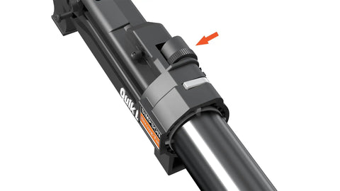 Close-up of Quik Drive tool adjustment knob on metal shaft with directional arrow for functionality guidance and secure fastening.