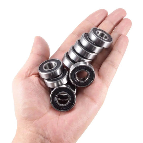 Hand holding 10-pack Half Inch Bore R8-2RS Double Sealed Ball Bearings for electric motors, wheels, home appliances, and garden machinery.