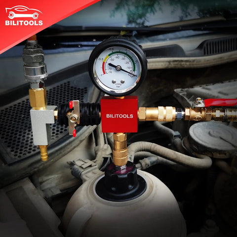 BILITOOLS 28-piece radiator coolant pressure tester kit with gauge and brass fittings, red block in car engine bay