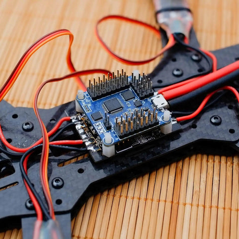 Silent, reliable RC vibration dampers that isolate the flight controller and gimbal from shocks, lowering sensitivity and smoothing aerial performance, fits F4/F7 controllers with M2x4mm mounts, pack of 20 black installed on drone frame.