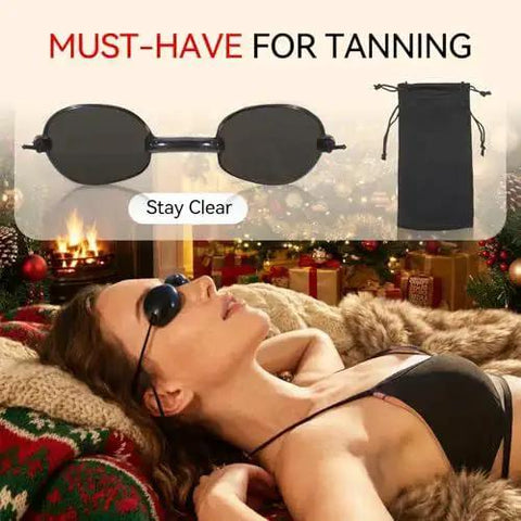 Woman wearing Red Light Therapy Glasses With Adjustable Fit For Eye Protection During Tanning, relaxing indoors.