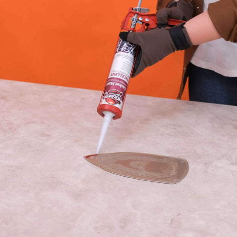 Person applying Red RTV Silicone Gasket Maker Sealant, Heavy Duty Automotive Grade, Oil Resistant And Heat Safe Up To 600F