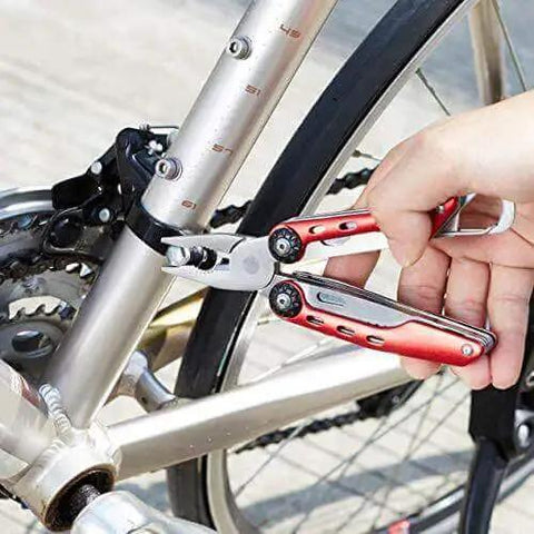 Using 10-In-1 Stainless Steel Multitool With Safety Lock And Red Nylon Sheath Including Needle Nose Pliers on bicycle
