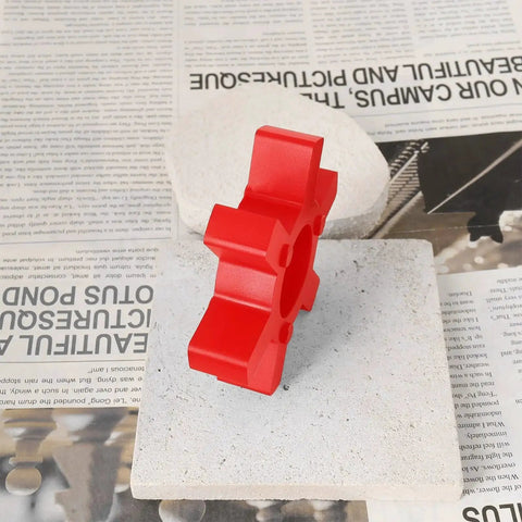 Red urethane jaw coupling insert L110 two pack for Lovejoy style L-jaw couplings on a stone tile with newspaper background.