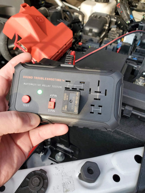 Person holding Automotive Relay Tester With Puller For 12V Cars And Trucks, DIY Friendly Relay Diagnostic Tool with LED indicators.