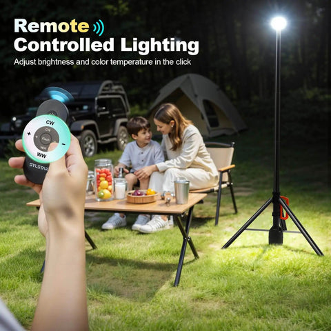 All Purpose 360 Degree Rechargeable Work Light With Remote Telescopic Stand Extends From 2.3 Feet To 8.4 Feet Ultra Bright 3000 Lumens Adjustable 3 CCT Dimming 6000mAh Battery Portable Camping And Jobsite Lighting For Workshop Sports And Emergencies lighting up a campsite at night.