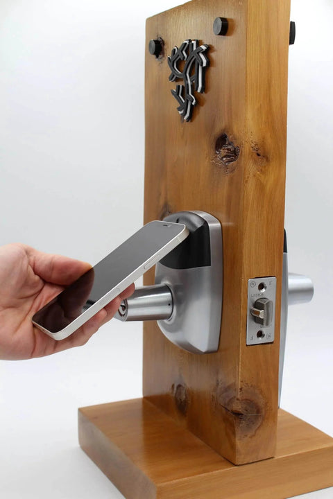 NFC smartphone unlocking RFID Commercial Lever Door Lock with App Access Control and includes 2 NFC keycards left hand on wood panel.