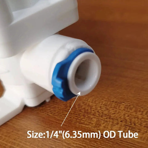 Close-up of 1/4 inch OD tube on water pressure relief regulator for reverse osmosis systems with quick connect fitting.