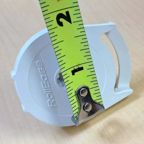 Clutch R Series with Bead Stopper (White, R8-1 1/8" Tube) close-up with yellow tape measure on wooden surface.