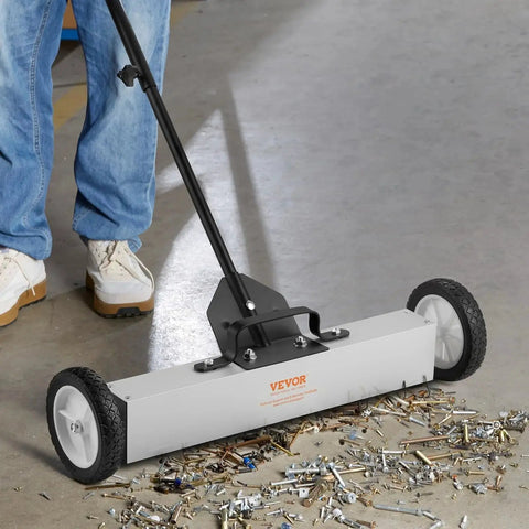 Effortless, heavy duty rolling magnetic sweeper with a 24 inch wide magnet and 50 lb pickup capacity, removing debris on floor