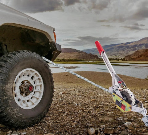 Three Quarter Ton Rope Puller Come Along Winch With 100 Ft Rope securing a vehicle on rugged terrain